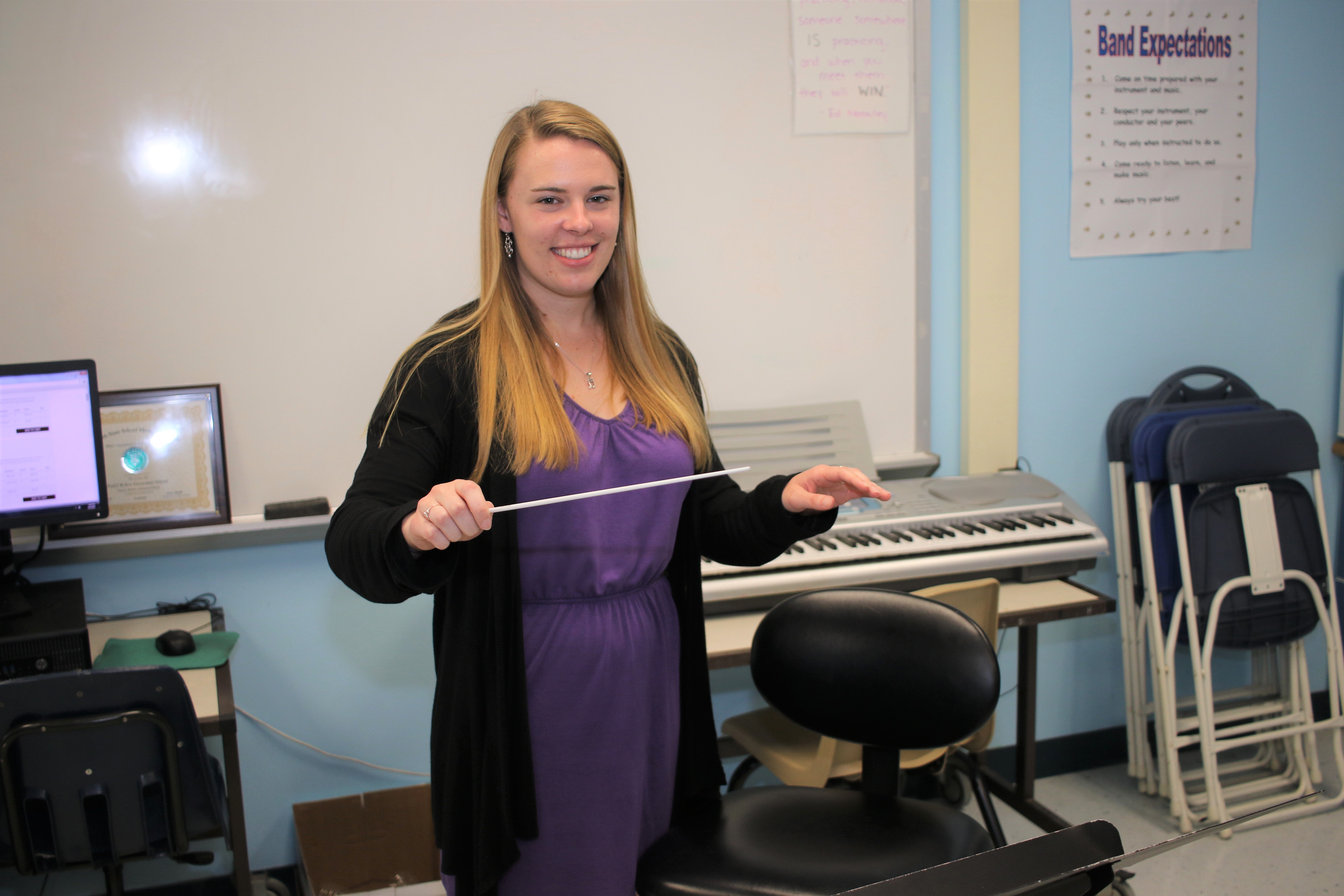 a teacher wearing a purple dress 